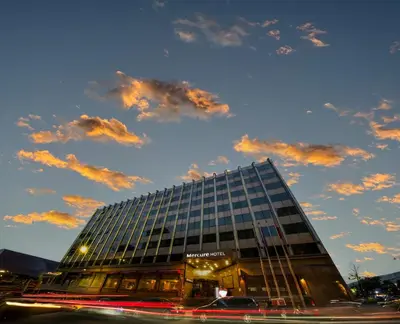 a tall glass building with a cloudy sky at Mercure Istanbul Bomonti in Istanbul