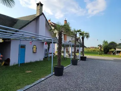 a house with palm trees in front of a street at Serbesler Botanik, No 1 Comfortable Villa in Sakarya