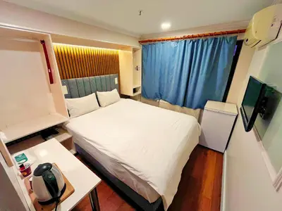 a small bedroom with a white bed and a table at Naila Hotel in Istanbul