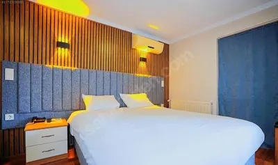 a bedroom with a large white bed in a room at Naila Hotel in Istanbul