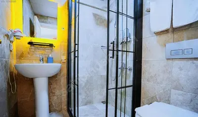 a bathroom with a shower and a sink and a toilet at Naila Hotel in Istanbul