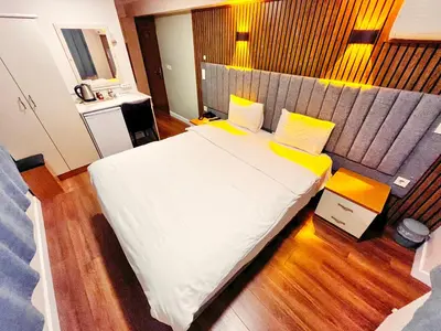 a bedroom with a large white bed with yellow pillows at Naila Hotel in Istanbul