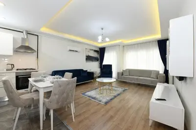 a kitchen and a living room with a table and chairs at Kardeş Suite 5 in Istanbul