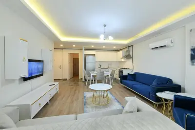 a living room with a blue couch and a table at Kardeş Suite 5 in Istanbul