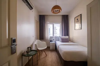 a hotel room with a bed and a table at Elite Marmara Express Otel in Istanbul