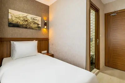 a bedroom with a white bed and a doorway at Diamond Beyazit Hotel in Istanbul