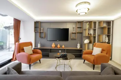 a living room with two chairs and a television at Diamond Beyazit Hotel in Istanbul