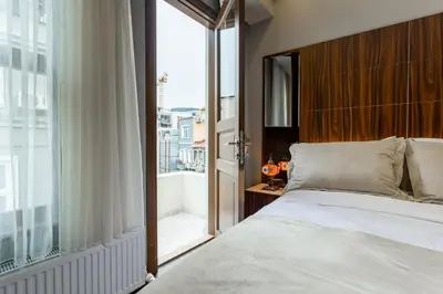 a bedroom with a bed and a large window at Dream Park Hotel in Istanbul
