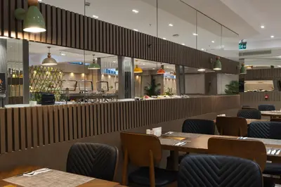 a restaurant with wooden tables and blue chairs at Buke Hotel Bomonti in Istanbul