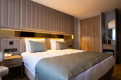 a hotel room with a large bed and a desk at Buke Hotel Bomonti in Istanbul