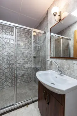 a bathroom with a shower and a sink and a mirror at Rose Apartments in Istanbul