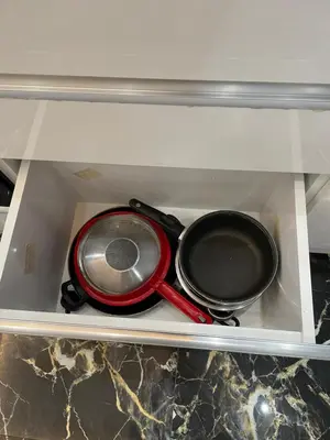 a stove with two frying pans in a drawer at Stay in the heart of the city in Istanbul