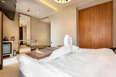 a bedroom with a large bed with white sheets at Santra Hotel in Istanbul