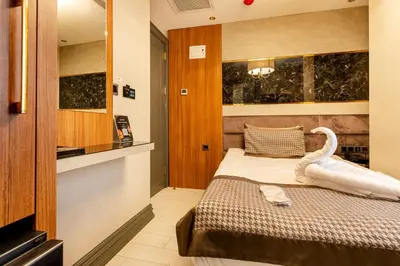 a bedroom with a bed with a swan on it at Santra Hotel in Istanbul