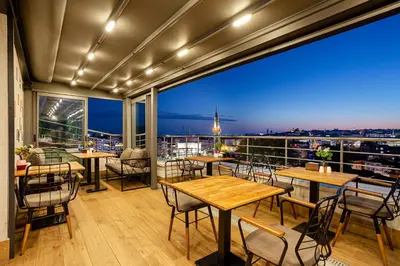 a restaurant with tables and chairs and a view of the city at Santra Hotel in Istanbul