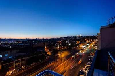a city street at night with cars on the road at Santra Hotel in Istanbul