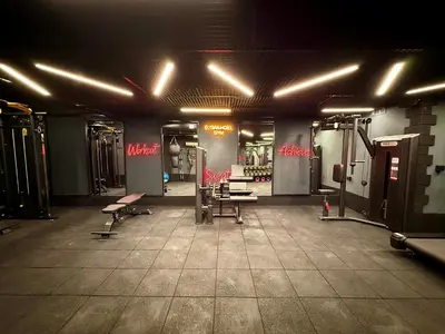 a gym with benches and equipment in a dark room at Elysian Airport Hotel & Restaurant in Arnavutköy