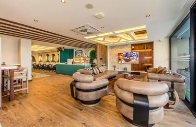 a lobby with couches and chairs and a bar at Elysian Airport Hotel & Restaurant in Arnavutköy