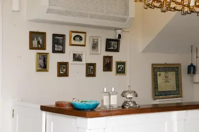 a kitchen with a counter with pictures on the wall at Aşiyan Yalısı in İznik