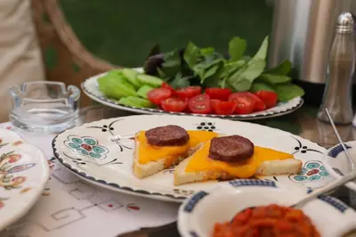 two plates of food on a table with fruits and vegetables at Aşiyan Yalısı in İznik