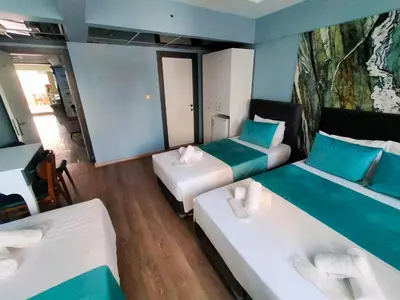 a room with three beds with blue and white at Grand Bona Sera Hotel in Istanbul