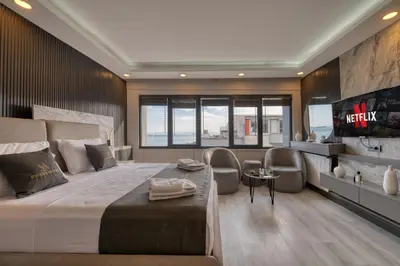 a bedroom with a large bed with chairs and a tv at Swans Hotel Old City Grand Bazar in Istanbul