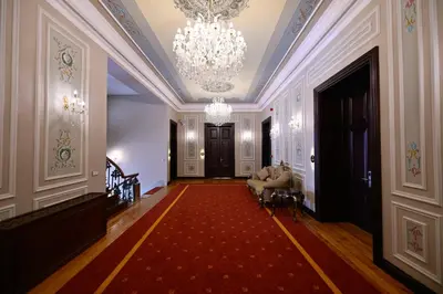 a hallway with a chandelier and a red carpet at Ring Stone Hotels Old City - Special Class in Istanbul