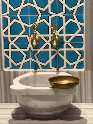 a bathroom with a white sink with a gold bowl at Ring Stone Hotels Old City - Special Class in Istanbul