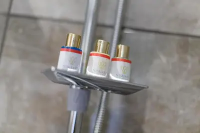 a group of four essential oils on a holder in a bathroom at Nishant Hotel in Istanbul