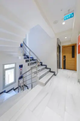 an empty hallway with stairs in an office building at Nishant Hotel in Istanbul