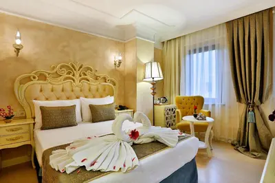 a hotel room with a bed with a dress on it at Edibe Sultan Hotel in Istanbul