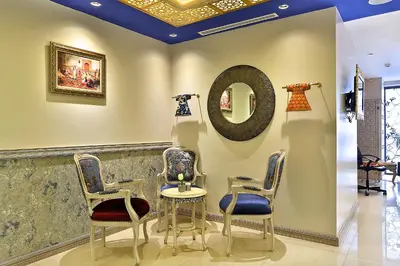 a salon with two chairs and a mirror at Edibe Sultan Hotel in Istanbul