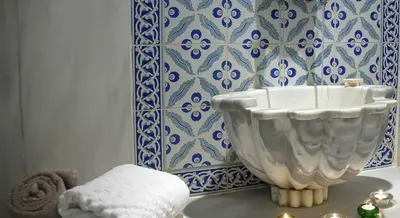 a white bowl sitting on a table in a bathroom at Edibe Sultan Hotel in Istanbul
