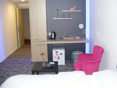 a room with a bed and a desk and chairs at KAT11 in Beylikduzu