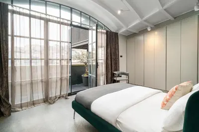 a bedroom with a large bed and a large window at RA Apartments in Istanbul