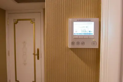 a television on a wall next to a door at Empire Suite Hotel in Istanbul