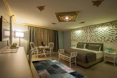 a hotel room with a bed and a table and chairs at Empire Suite Hotel in Istanbul