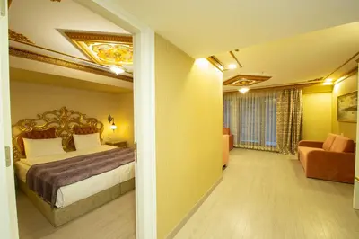 a hotel room with a bed and a couch at Empire Suite Hotel in Istanbul