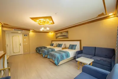 a hotel room with a bed and a couch at Empire Suite Hotel in Istanbul