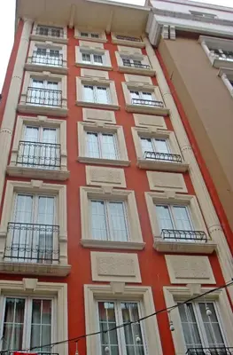 a tall orange building with windows and balconies at Konak Apart Hotel in Istanbul