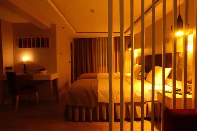 a bedroom with a bed and a desk and a bed sidx sidx sidx at Carina Park Suites Nisantasi in Istanbul