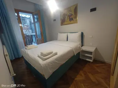 a small bedroom with a bed with two towels on it at Buyukada Cinar Hotel in Buyukada