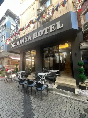 a hotel with tables and chairs in front of a building at Öz Dünya Hotel in Istanbul