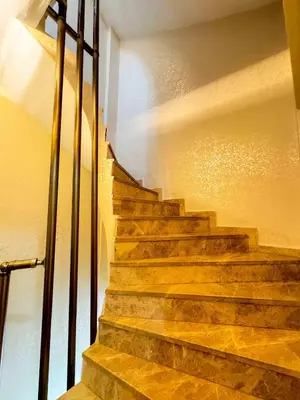a set of stairs in a building with sunlight at Öz Dünya Hotel in Istanbul