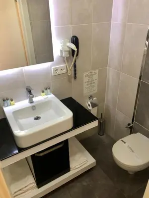 a bathroom with a sink and a toilet at Era Palace Hotel in Istanbul