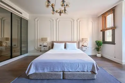a bedroom with a large bed and a chandelier at Taksim Lagirio Residence in Istanbul