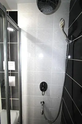 a small bathroom with a shower and a toilet at Metrohill Hotel in Istanbul