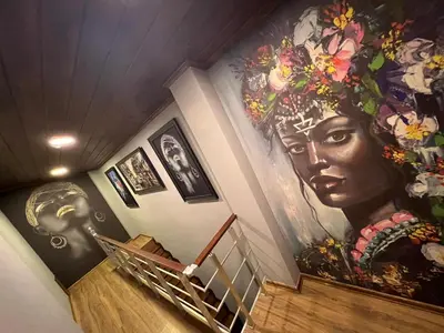 a staircase with a large painting of a woman on the wall at Bonita Hotel in Istanbul