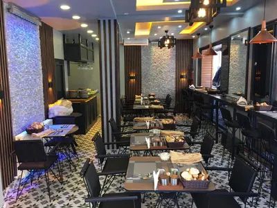 a restaurant with tables and chairs and a bar at Bonita Hotel in Istanbul