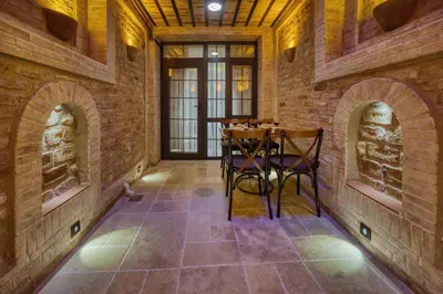 a dining room with brick walls and a table and chairs at Mahhsen Mansion Oldcity in Istanbul